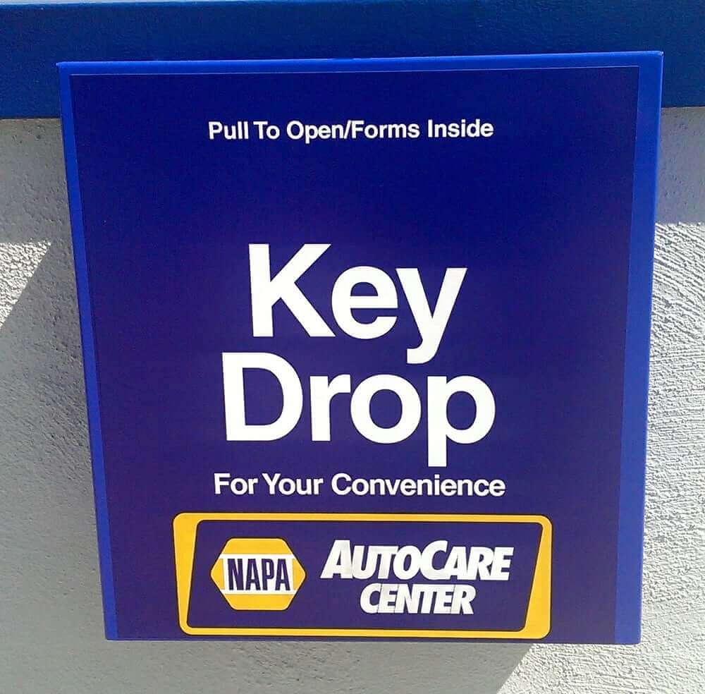 Napa early bird key drop box on side of a shop