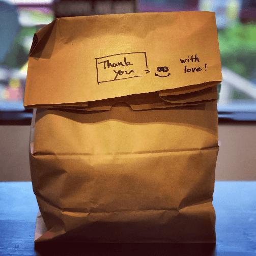 show your employees appreciation with delivery; image of brown paper delivery bag with 'thank you' and 'with love' written on it in permanent black marker