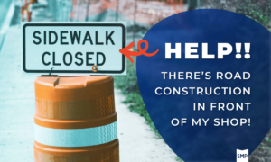 Help! There’s Road Construction In Front Of My Shop! text with Shop Marketing Pros SMP logo beneath it in blue blob with squiggly red arrow pointing to a construction cone with a DOTD white and black "Sidewalk Closed" sign ontop
