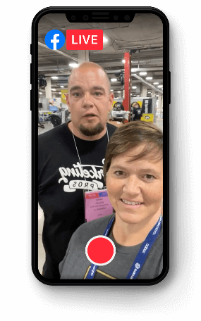 Shop Marketing Pros owners Kim and Brian Walker pictured on a smart phone while doing a Facebook Live video while at an Expo