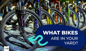Close-up of bike front wheels lined up with text "What bikes are in your yard?" and an arrow pointing to a bike.