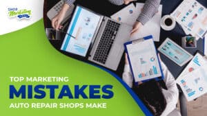 Top view of a table with two office workers discussing marketing reports. With laptop, tablet, clipboard, papers reports, and pens on a black table. With Shop Marketing Pros logo on the right upper side and the title “Top Marketing Mistakes Auto Repair Shops Make” at the lower right side.